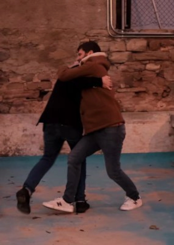 Bill Laurance and Michael League hugging each other