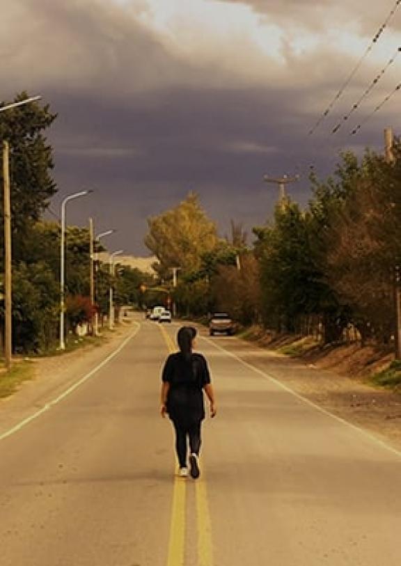 A woman standing in the middle of a street